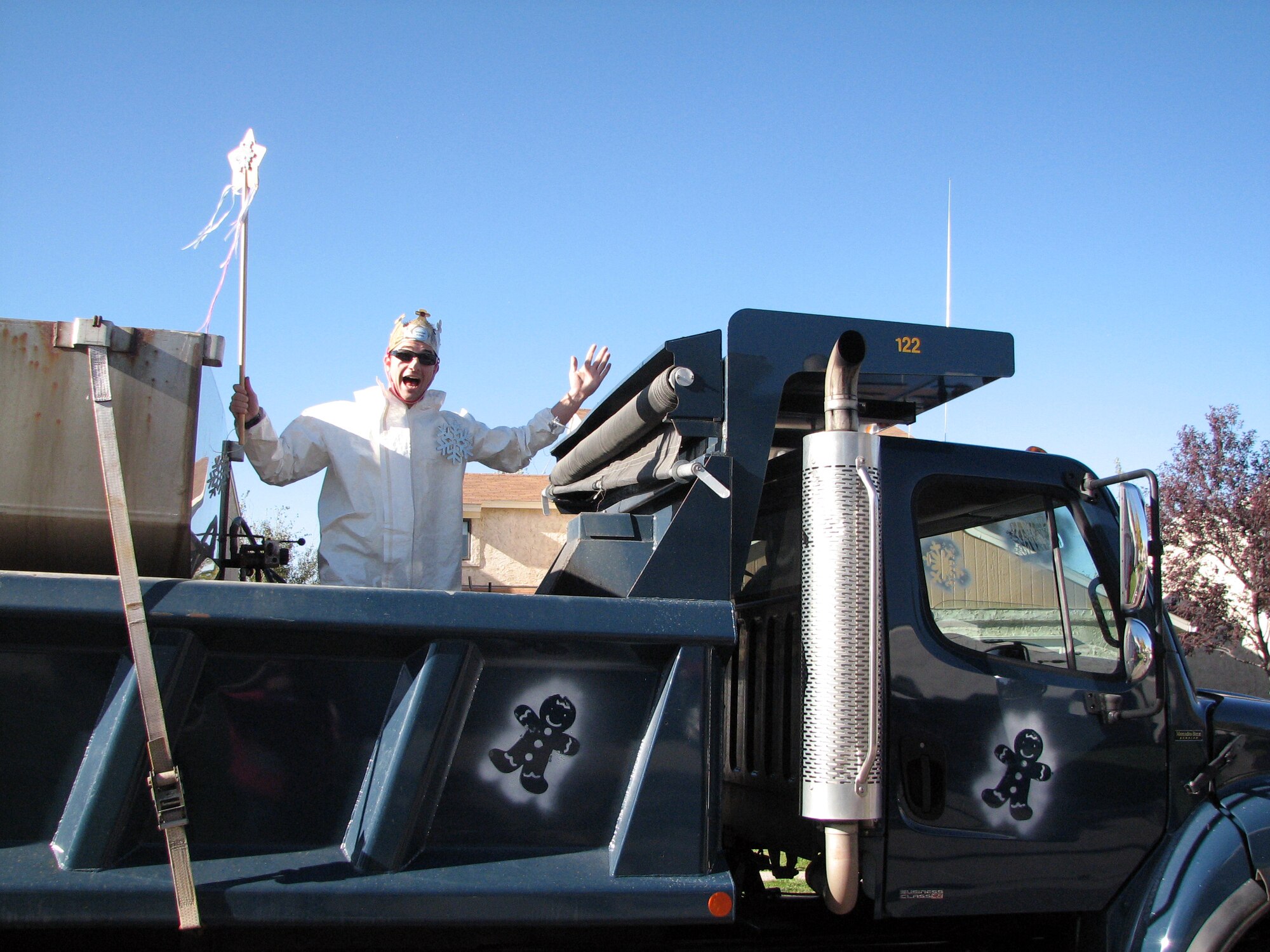 Second Lt. Colby Gregory, 90th Civil Engineering Squadron Snow King, casts a snow spell in the back of a dump truck during the 2010 Snow Parade here, Sept. 30. (Courtesy photo)