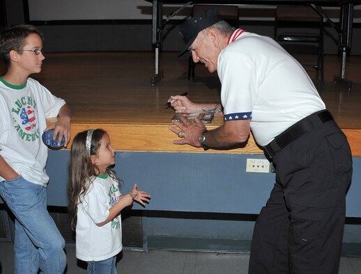 Actor and retired Marine Gunnery Sgt. R. Lee Ermey visited Kirtland AFB Sept. 22 while in Albuquerque for the National Police Shooting Championships.

Mr. Ermey signs an autograph for five-year-old Rachel Parker. U.S. Air Force Photo by Todd Berenger