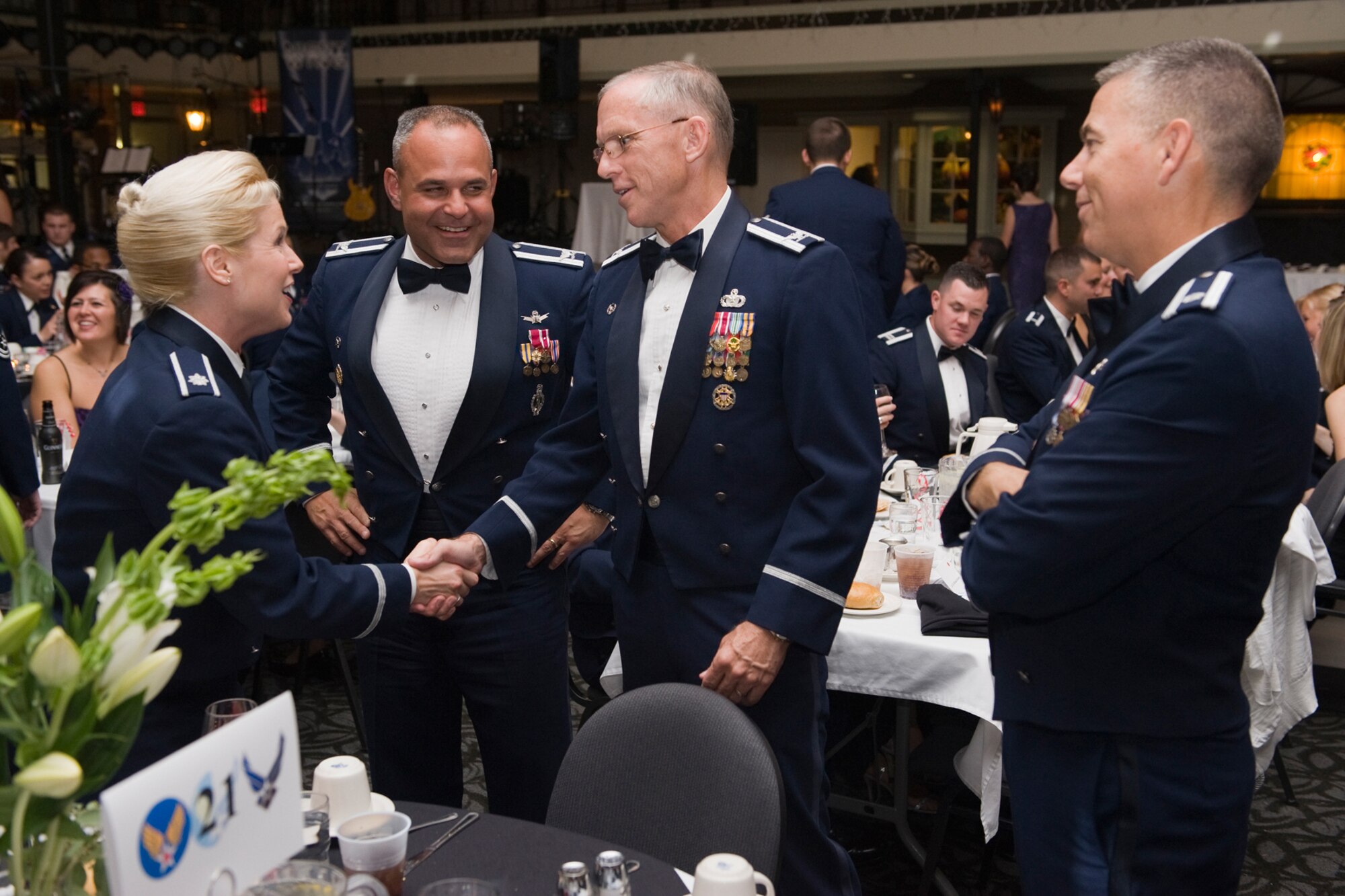 Col. Robert Mendenhall, 341st Security Forces Group commander, congratulates Lt. Col. Natalie Bonetti, 341st Missile Wing Inspector General, while Col. Mohammed "Mo" Khan, 341st Operations Group commander (center) and Lt. Col. John Ard, 10 Missile Squadron Director of Operations, look on. Colonel Bonetti was promoted to her current rank the day prior on Oct. 1. (U.S. Air Force photo/Beau Wade)