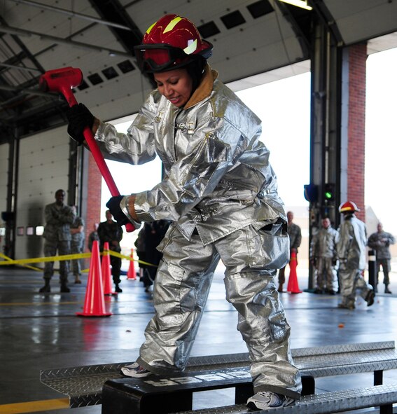 RAF MILDENHALL, England -- Staff Sgt. Fantasia Espinoza, 100th Maintenance Squadron, hits the Kaiser sled during the individual event at the fire muster Oct. 7, 2010. Sergeant Espinoza placed second in the individual female event. (U.S. Air Force photo/Karen Abeyasekere)