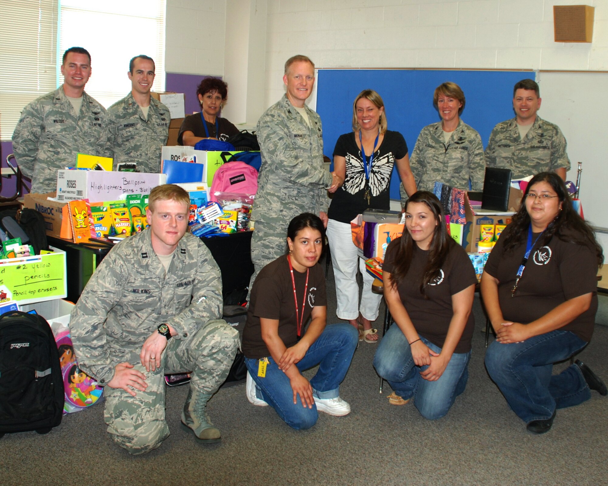 Members of the Space Development and Test Wing are on hand for the presentation of supplies to Kirtland Elementary school. U.S. Photo by Dennis Carlson