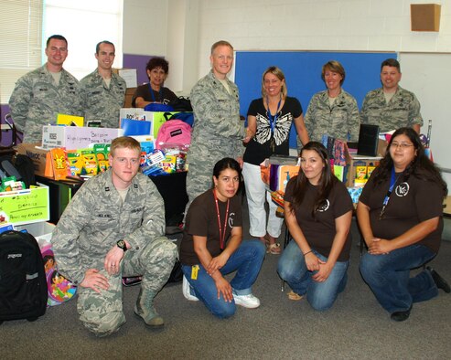 Members of the Space Development and Test Wing are on hand for the presentation of supplies to Kirtland Elementary school. U.S. Photo by Dennis Carlson
