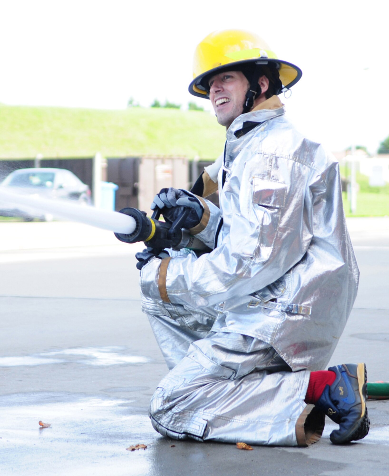 RAF MILDENHALL, England -- Andrew Keogh, 100th Civil Engineer Squadron, fires the hose at a target during the individual event at the fire muster Oct. 7, 2010, held as part of Fire Prevention Week. During the individual event participants had to do all of the events by themselves, except throwing water at the "burning house." (U.S. Air Force photo/Karen Abeyasekere)