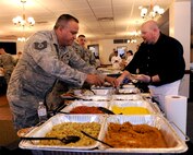 MOODY AIR FORCE BASE, Ga. -- Tech. Sgt. George Aguilar, 23rd Maintenance Group knowledge operator, tries the new food set on display at the Georgia Pines Dining Facility as Jon Hagler, food representative, serves other military members here Oct. 7. New foods were taste-tested to get the opinion on what new foods will be introduced into the dining facility. (U.S. Air Force photo/Airman 1st Class Benjamin Wiseman) 