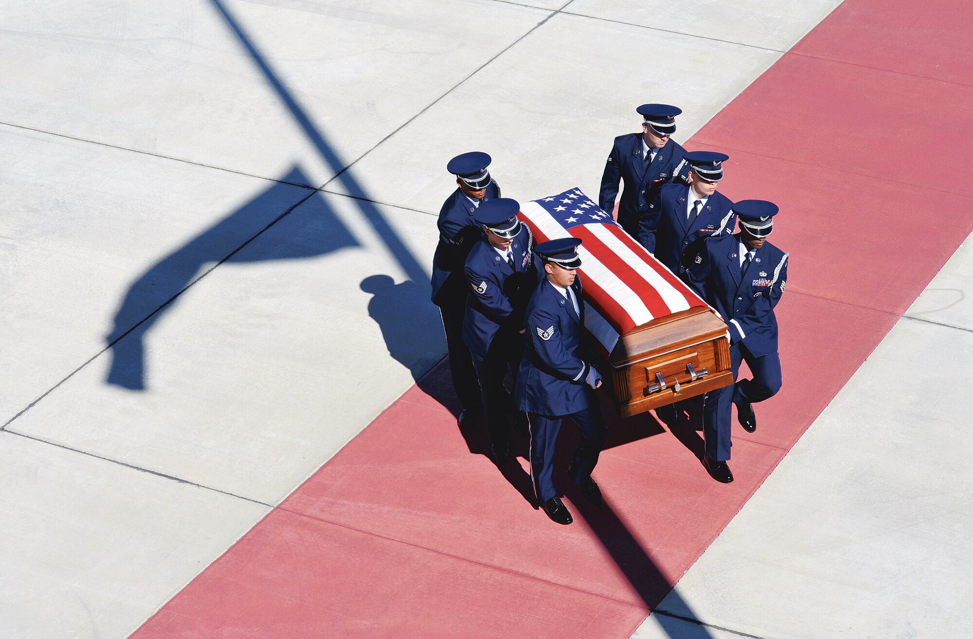 Robins Honor Guard members carry the casket of Senior Airman Michael Buras to an awaiting hearse on the Robins flightline Saturday. U. S. Air Force photo by Gary Cutrell