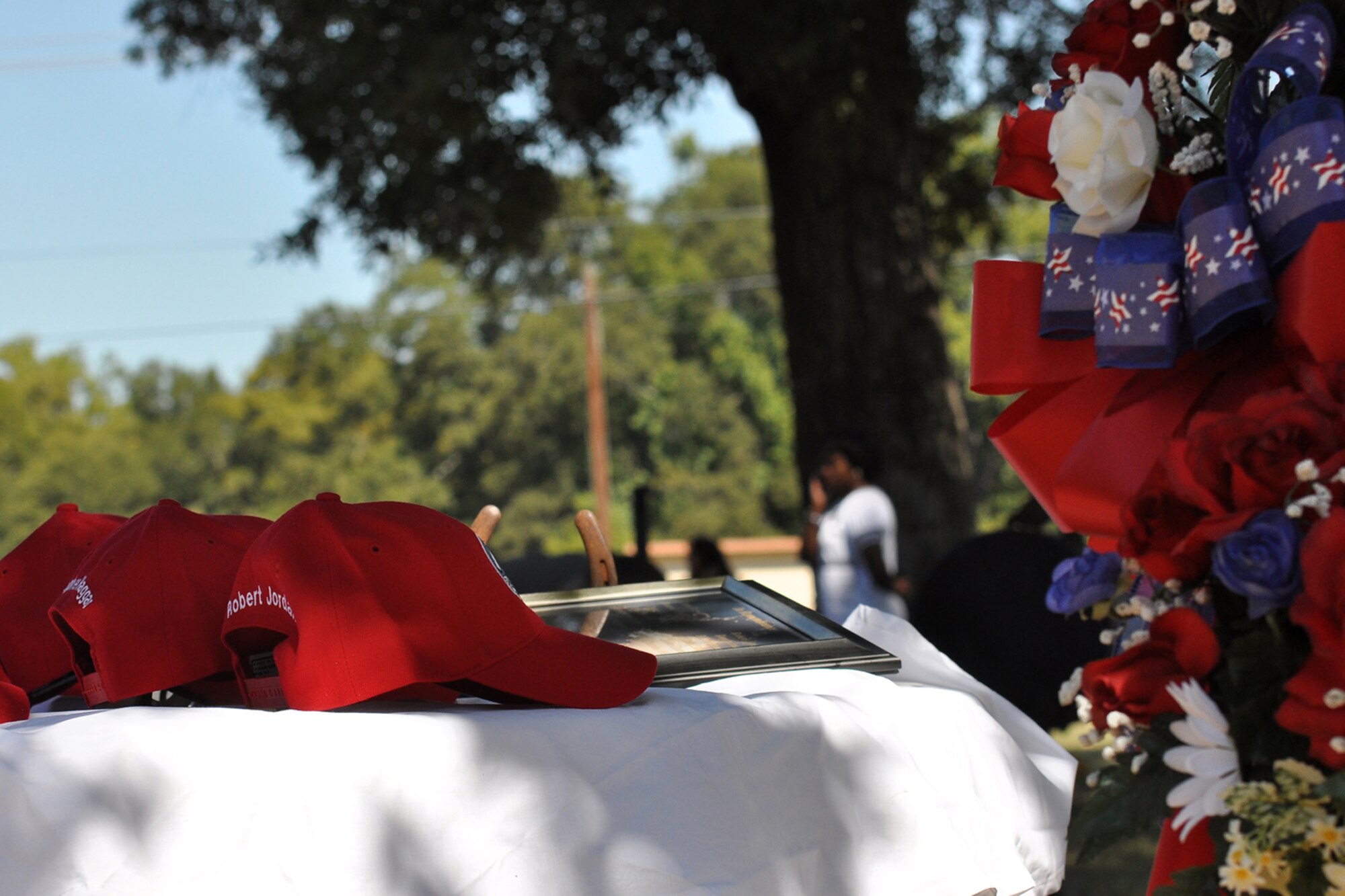 A small table with the names of members who have passed away stands as a memorial at the 307th REDHORSE Squadron family day at Cullen Park on Barksdale Air Force Base, La., Oct 2, 2010. All members, families and friends were treated to an afternoon of food, fun, karaoke and camaraderie. There were also events specially designed for children, which included games and an air castle.  (Photo by Master Sgt. Mary Hinson)