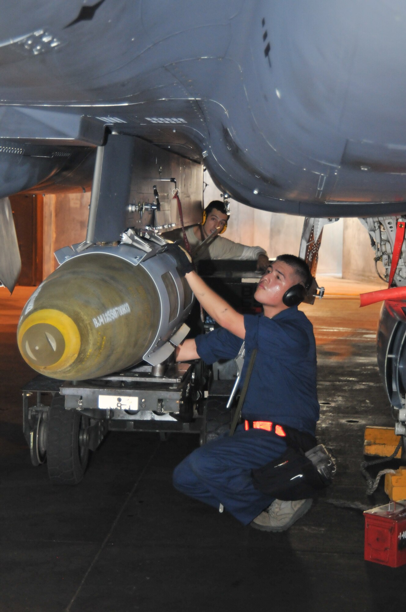 ROYAL AIR FORCE LAKENHEATH, England -- Tech. Sgt. Salvador Bravo, 48th Maintenance Group weapons load crew chief (in coveralls), and Senior Airman Alex Ponzi, 48th Maintenance Group weapons load crew ‘three’ man, load a GBU-31 bomb onto an F-15E Strike Eagle Oct. 7.  Set piece demonstrations involve five-man teams tasked with regenerating an aircraft within a specified time limit in preparation for the NATO Tactical Evaluation. (U.S. Air Force photo/Senior Airman David Dobrydney)