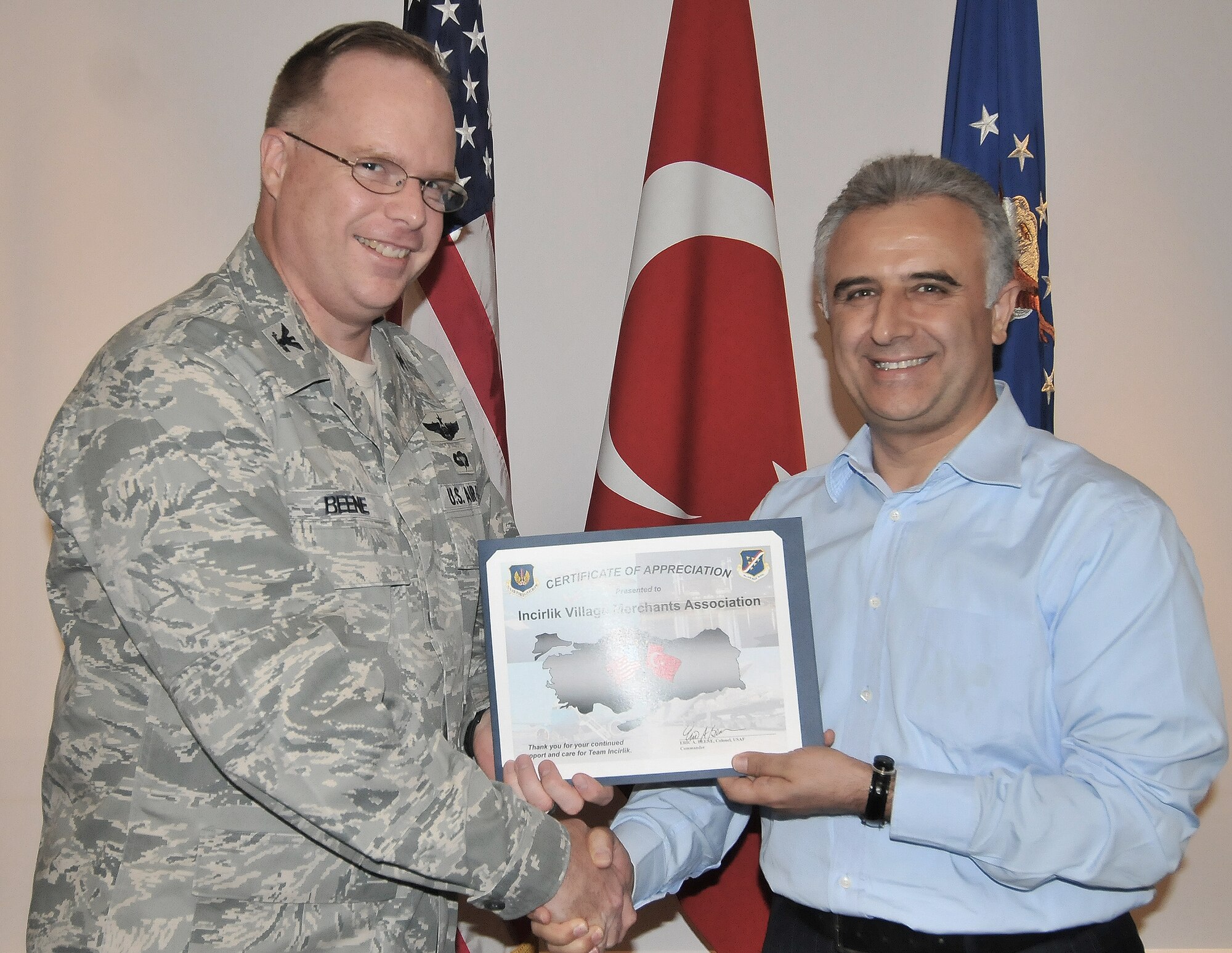Col. Eric Beene, 39th Air Base Wing commander, presents Yilmar Gizir, Incirlik Village Merchant’s Association chairman, a certificate of appreciation Oct. 7, 2010 at Incirlik Air Base, Turkey.  Mr. Gizir was presented the certificate to show appreciation to merchants in the Alley for their continued vigilance and support.  Local merchants outside Incirlik AB work together keeping the area safe on a daily basis. (U.S. Air Force Photo/Senior Airman Alexandre Montes/Released)