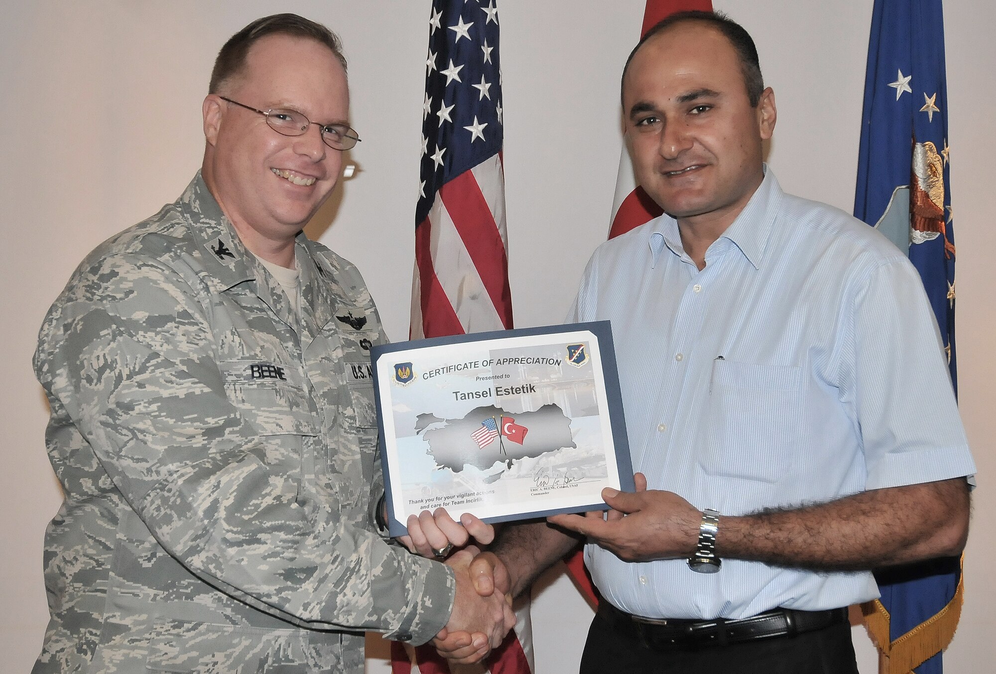 Col. Eric Beene, 39th Air Base Wing commander, presents Tansel Estetik, a store owner in the “Alley” a certificate of appreciation Oct. 7, 2010 at Incirlik Air Base, Turkey. Local merchants outside Incirlik AB work together keeping the area safe on a daily basis. (U.S. Air Force Photo/Senior Airman Alexandre Montes/Released)