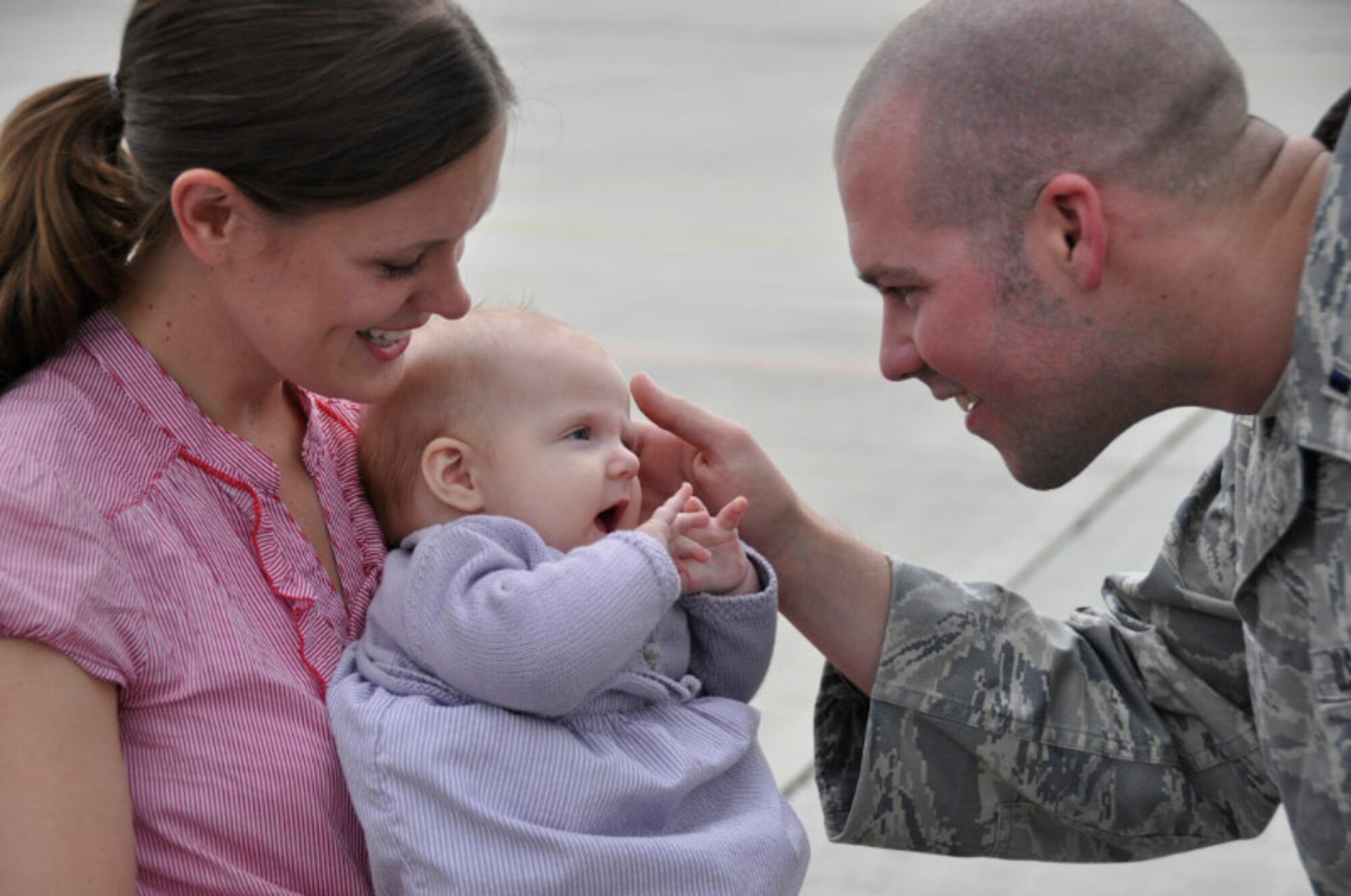 First Lt. William Whiddon, 510th Fighter Squadron Intelligence officer in charge, meets his daughter for the first time Oct. 4 at the PAHA. Lieutenant Whiddon came back from a deployment in support of Operation Enduring Freedom. (Courtesy photo)