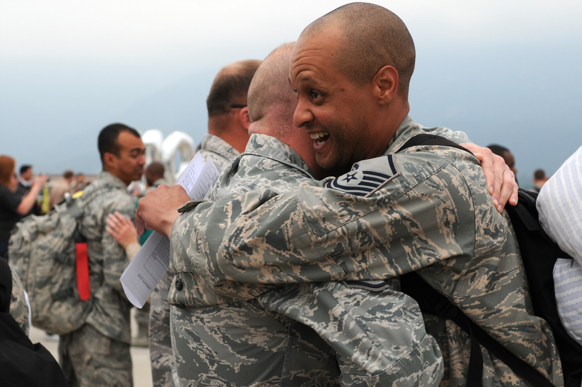 Master Sgt. Shea Bert, 31st Munitions Squadron line delivery section chief, receives a warm welcome Oct. 4 at the Personnel Alert Holding Area. Sergeant Bert was deployed for more than four months in support of Operation Enduring Freedom. (U.S. Air Force photo/Staff Sgt. Julius Delos Reyes)