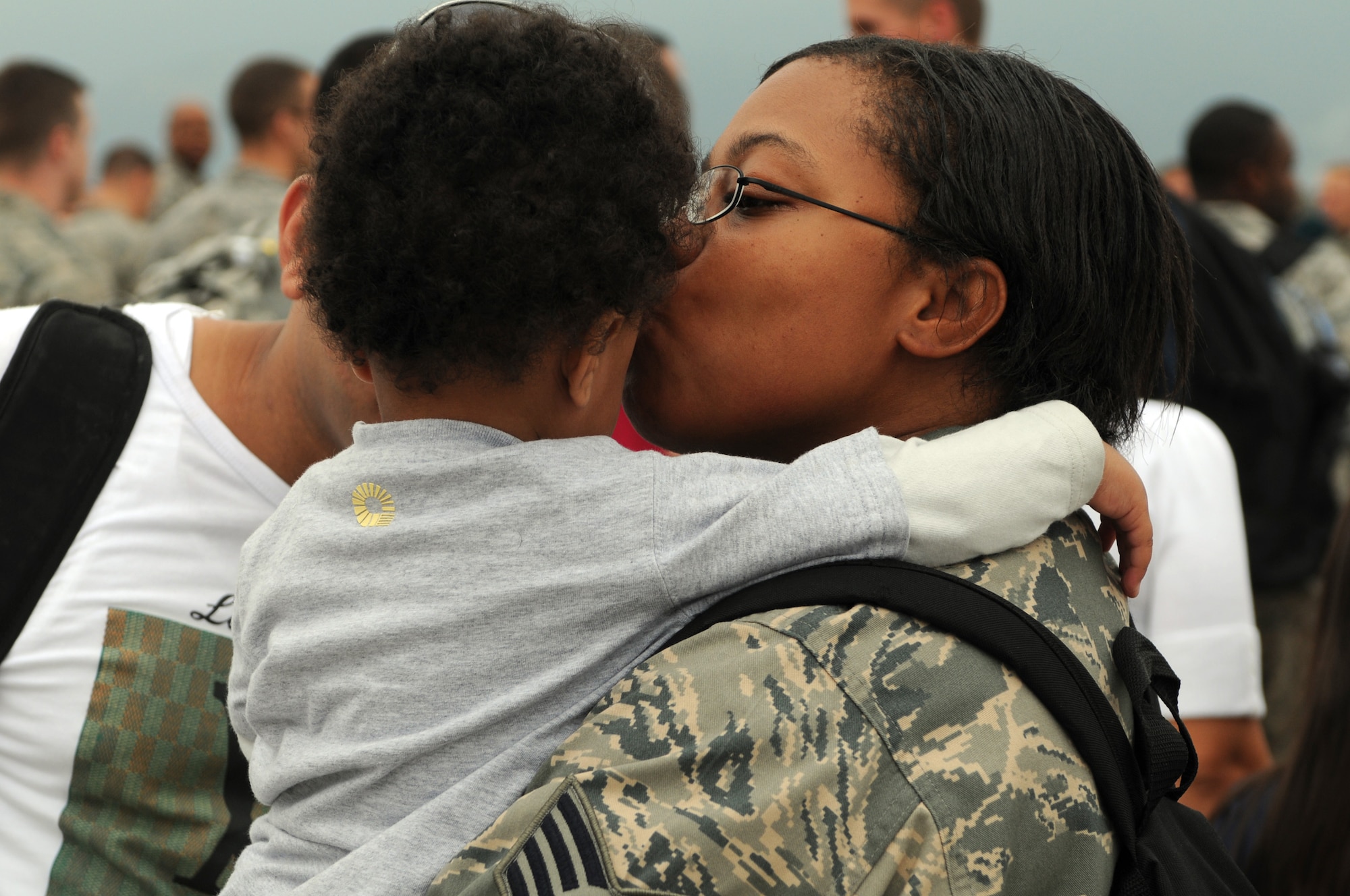 Staff Sgt. Surnicke Graham, 31st Logistics Readiness Squadron assistant NCO in charge of receiving, kisses her child Oct. 4 at the Personnel Alert Holding Area. Sergeant Graham was deployed for approximately four and a half months in support of Operation Enduring Freedom. (U.S. Air Force photo/Staff Sgt. Julius Delos Reyes)
