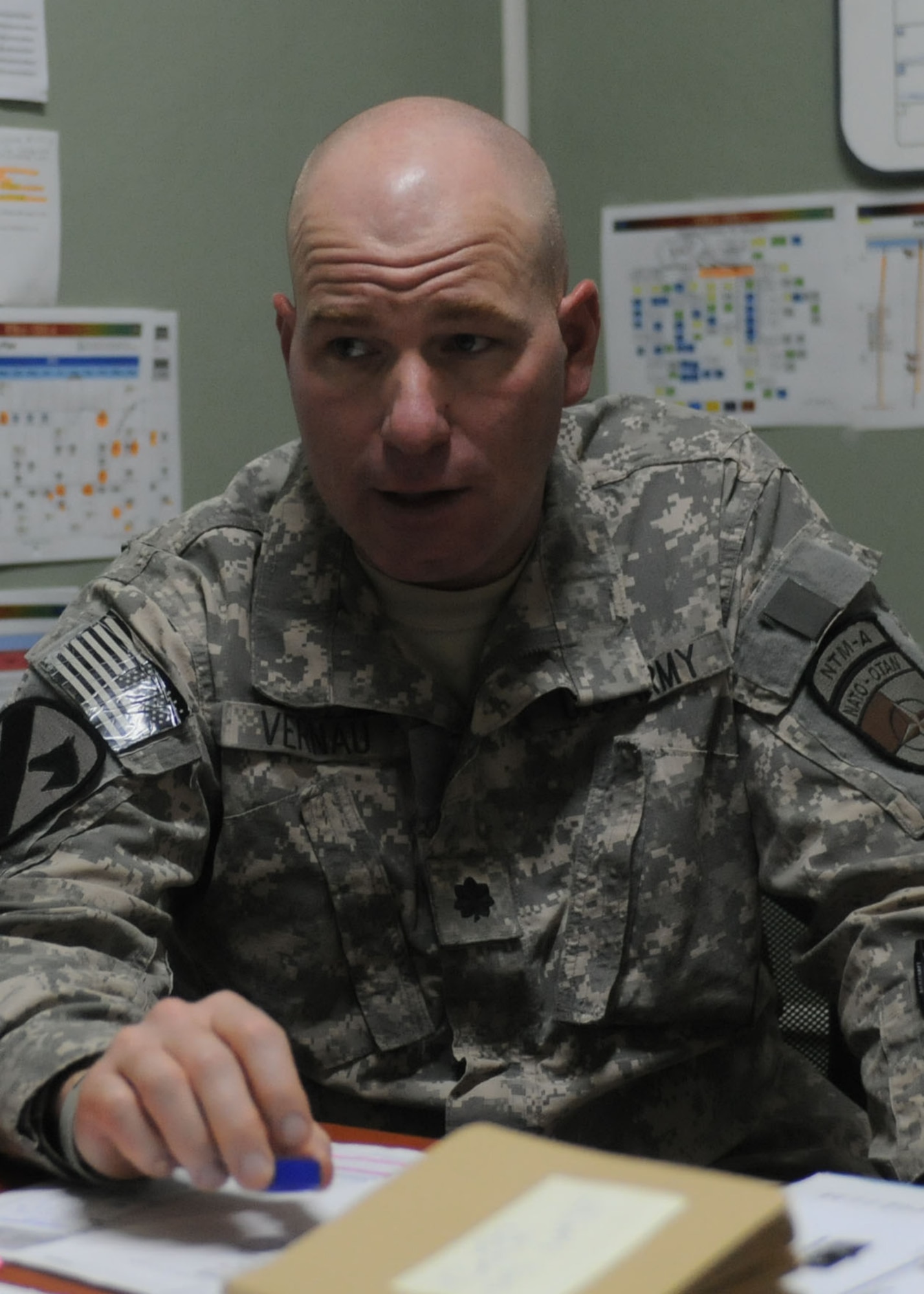 Camp Stone, Afghanistan – Lt. Col. Thomas N. Tran with the NATO Air Training Command - Afghanistan (left) and Lt. Col. Jonathan W. Vernau, in charge of Regional Support Team – West, and Lt. Col. Chris Shields of the United States Army talk about land agreements between local population and the Ministry of Defense. They are working out the land ownership details, so when U.S. forces leave, the land will belong to the Ministry of Defense.  So there will be no disagreements in the future over who owns the land.  (U.S. Navy photo by Mass Communication Specialist 3rd Class Jared E. Walker/ RELEASED).