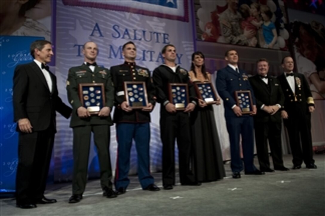 President of USO Sloan Gibson (left) and USO Service members of the Year U.S. Army Sgt. Zachary C. Dispennette (2nd from left), U.S. Marine Corps Sgt. Eric B. Walker, U.S. Navy Petty Officer 2nd Class Kenton J. Stacy, mother of an award recipient Kimberly Watkins, U.S. Air Force Staff Sgt. Gino P. Kahaunaele, U.S. Coast Guard Petty Officer 3rd Class Robert D. Emley, President of the USO board of Governors Edward T. Reilly and Chairman of the Joint Chiefs of Staff Adm. Mike Mullen pose for photos at the USO Gala at the Marriott Wardman Park Hotel in Washington, D.C., on Oct. 7, 2010.  