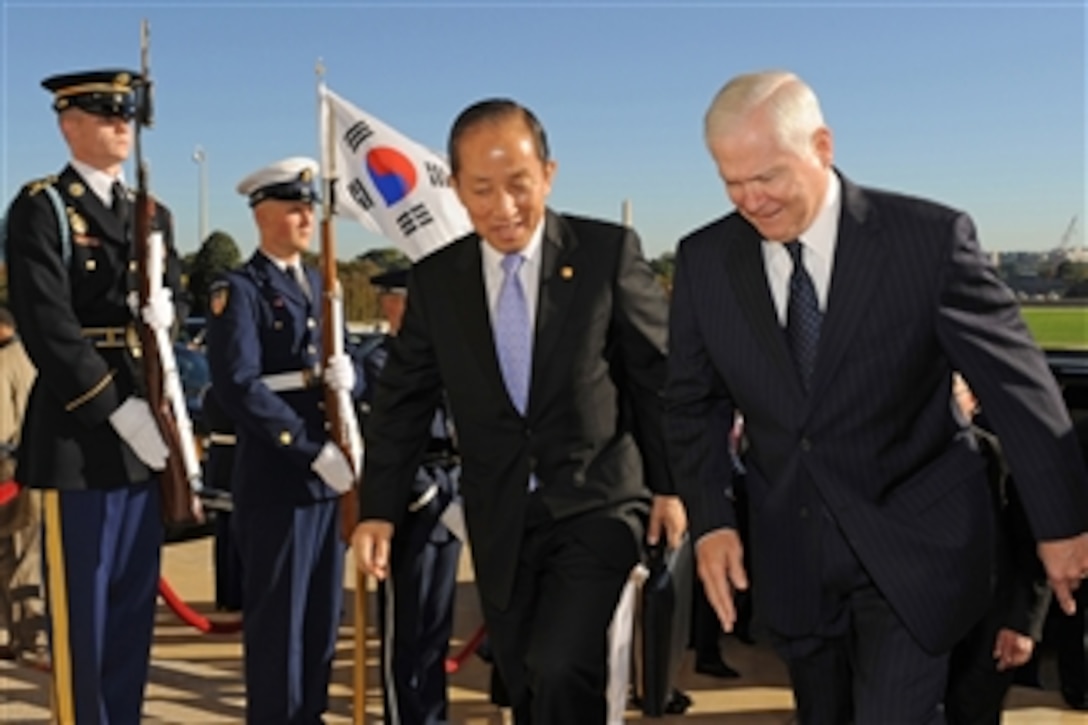 Secretary of Defense Robert M. Gates (right) escorts South Korean Minister of National Defense Kim Tae-young through an honor cordon and into the Pentagon on Oct. 8, 2010.  