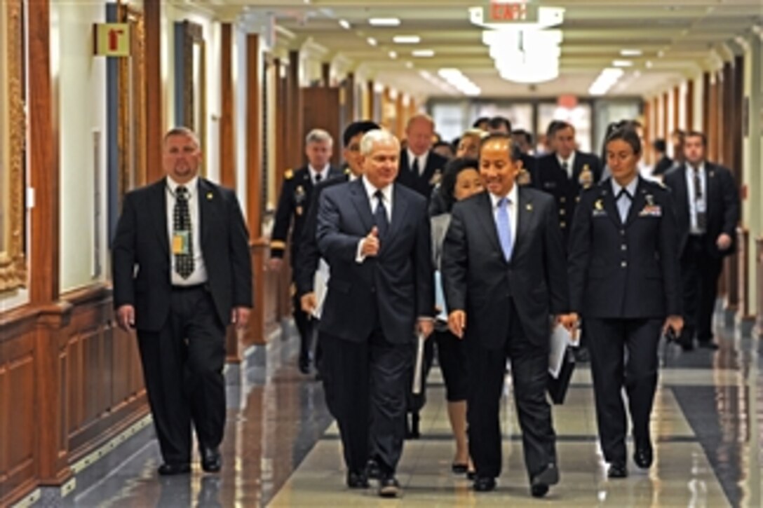 Secretary of Defense Robert M. Gates (2nd from left) talks with South Korean Minister of National Defense Kim Tae-young as they walk down the Pentagon executive corridor on Oct. 8, 2010.  Gates and Tae-young are enroute to a plenary session as part of the 42nd annual Security Consultative Meeting held between the two nations.  