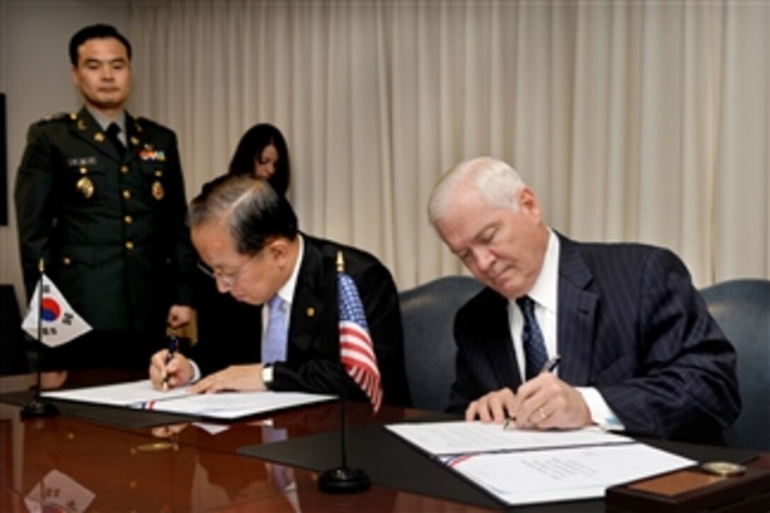 Secretary of Defense Robert M. Gates (right) and South Korean Defense Minister Kim Tae-young sign a series of documents representing agreements reached during the 42nd annual Security Consultative Meeting held between the two long-time allies in the Pentagon on Oct. 8, 2010.  
