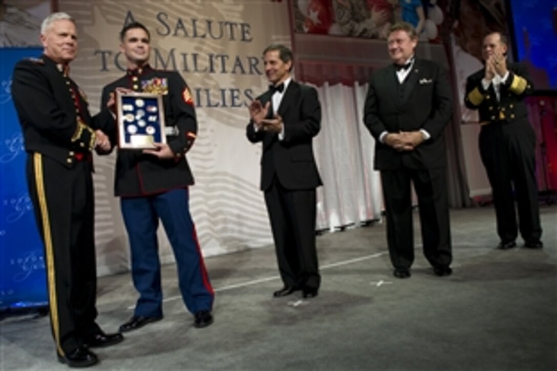 U.S Marine Corps Gen. James F. Amos, left, assistant commandant of the Marine Corps, USO President Sloan Gibson, center, Edward T. Reilly, second right, president of the USO board of Governors and Navy Adm. Mike Mullen, chairman of the Joint Chiefs of Staff, congratulate U.S. Marine Corps Sgt. Eric B. Walker, USO Marine of the Year, at the USO Gala at the Marriott Wardman Park Hotel in Washington, D.C., Oct. 7, 2010.