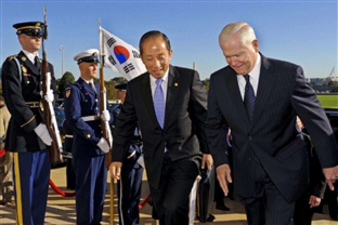 U.S. Defense Secretary Robert M. Gates, right, escorts his South Korean counterpart National Defense Minister Kim Tae-young through an honor cordon into the Pentagon, Oct. 8. 2010. The two defense leaders will talk during an annual security meeting between the two countries.  