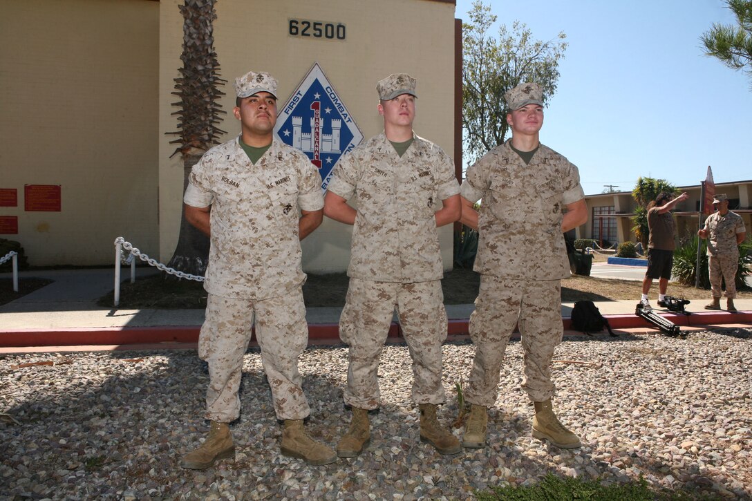 Pfcs. Anthony S. Roldan, Christopher M. Smith and Ryan J. Shuey, combat engineers with 1st Combat Engineer Battalion, 1st Marine Division, stand at parade rest in front of 1st CEB's headquarters building at the San Mateo training area Oct. 8. On Oct. 6, the Marines assisted a police officer with the Long Beach Police Department who had been violently attacked by a suspect yeilding a knife. Roldan, is an 18-year-old from Long Beach, Calif., Smith is a 20-year-old from Lemoore, Calif., and Shuey is a 20-year-old from Huntingdon County, Pa.