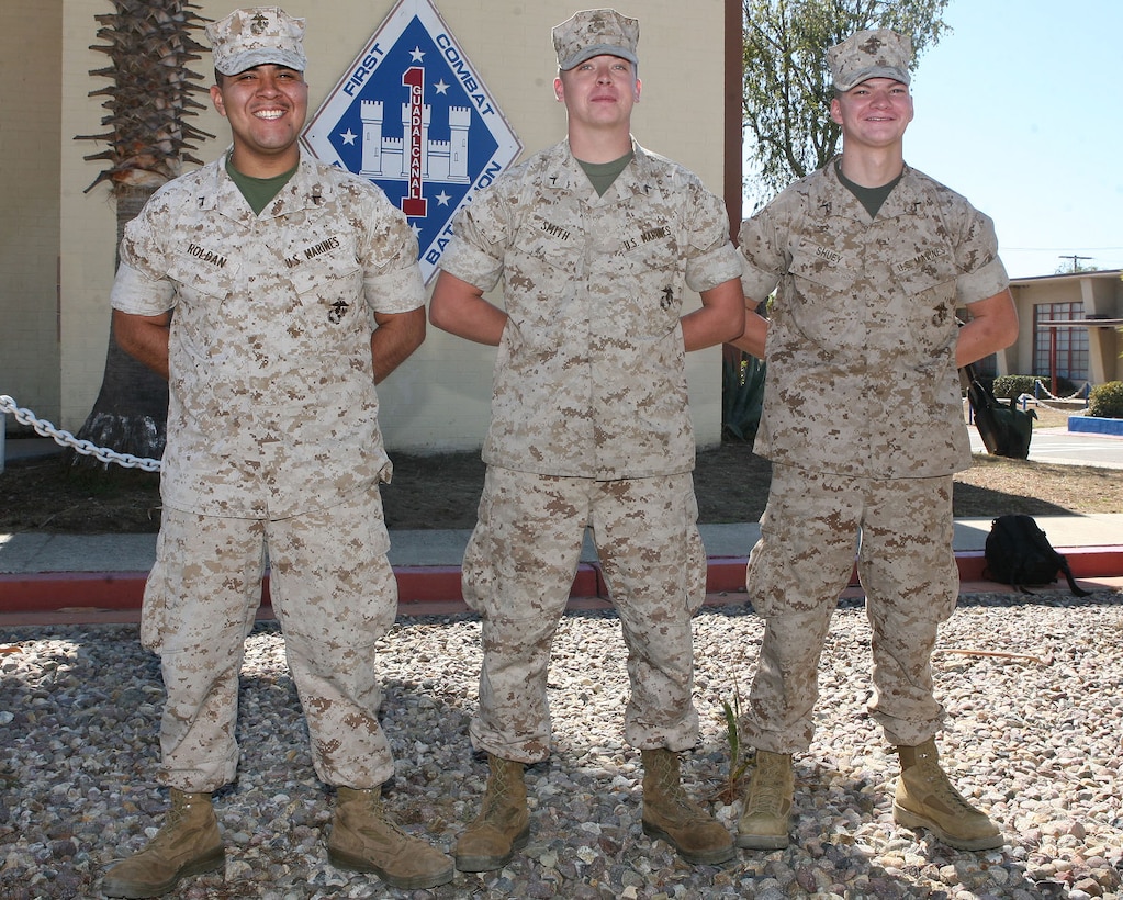 Pfcs. Anthony S. Roldan, Christopher M. Smith and Ryan J. Shuey, combat engineers with 1st Combat Engineer Battalion, 1st Marine Division, stand at parade rest in front of 1st CEB's headquarters building at the San Mateo training area Oct. 8. The Marines were presented with 1st CEB Sapper Coins by Lt. Col. Andrew Niebel, commanding officer of 1st CEB, for their actions Oct. 6 when they assisted a police officer with the Long Beach Police Department who was violently attacked by a suspect yielding a knife. Roldan, is an 18-year-old from Long Beach, Calif., Smith is a 20-year-old from Lemoore, Calif., and Shuey is a 20-year-old from Huntingdon County, Pa.