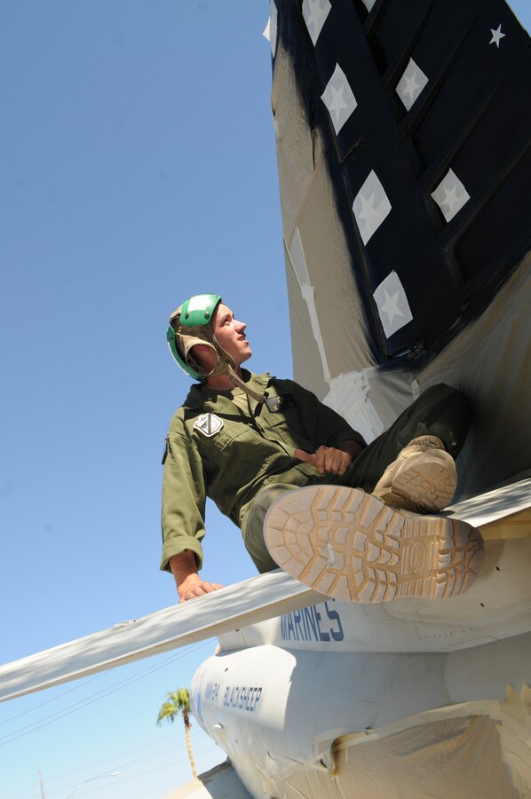 Cpl. James Doane, Marine Attack Squadron 214 airframes mechanic, puts the finishing touches on a tail design for the A-4L Skyhawk on display at the entrance to the Marine Corps Air Station in Yuma Ariz., Oct. 8, 2010. The Skyhawk project, slated to be finished Oct. 14, 2010, took approximately three weeks to complete, with only three Marines working 10- to 12-hour shifts. “I think the coolest part is that it’s our artwork,” said Doane. "It’s rewarding, putting personal touches to a project that expands the legacy of the Blacksheep," added Lance Cpl. Seth Hobbs, VMA-214 airframes mechanic.