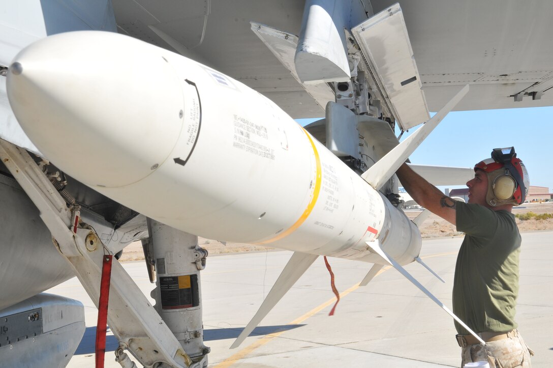 Staff Sgt. Robert Farmer, Marine Tactical Electronic Warfare Squadron 4 ordnance chief, prepares a high-speed, anti-radiation missile, after mounting it on an EA-6B Prowler jet with the rest of the VMAQ-4 ordnance team at the Marine Corps Air Station in Yuma, Ariz., Oct. 8, 2010. Later, the Prowler jets fired nine HARMs at targets in the Pacific Ocean. The squadron specializes in electronic warfare using the HARM, which detects electromagnetic radiation given off by enemy radars or anti-aircraft weapons, and is also the only missile Prowlers launch.