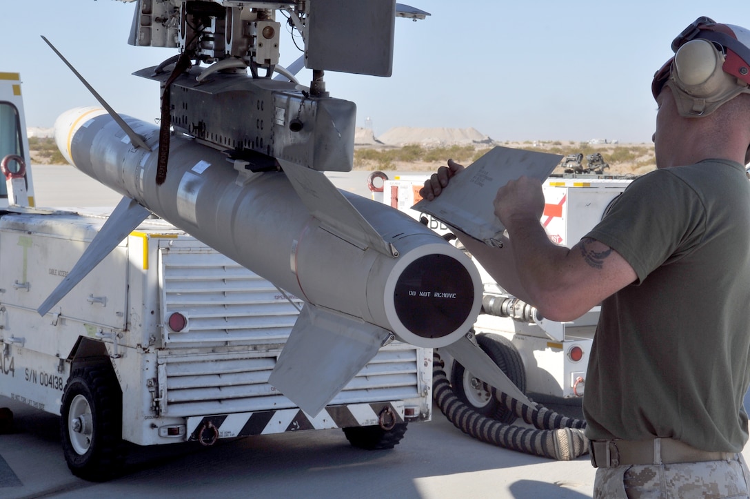 Staff Sgt. Robert Farmer, Marine Tactical Electronic Warfare Squadron 4 ordnance chief, attaches a fin to a high-speed, anti-radiation missile after mounting it on an EA-6B Prowler jet with the rest of the VMAQ-4 ordnance team at the Marine Corps Air Station in Yuma, Ariz., Oct. 8, 2010. Later, the Prowler jets fired nine HARMs at targets in the Pacific Ocean. The Cherry Point, N.C.,-based squadron specializes in electronic warfare using the HARM, which detects electromagnetic radiation given off by enemy radars or anti-aircraft weapons, and is also the only missile Prowlers launch.