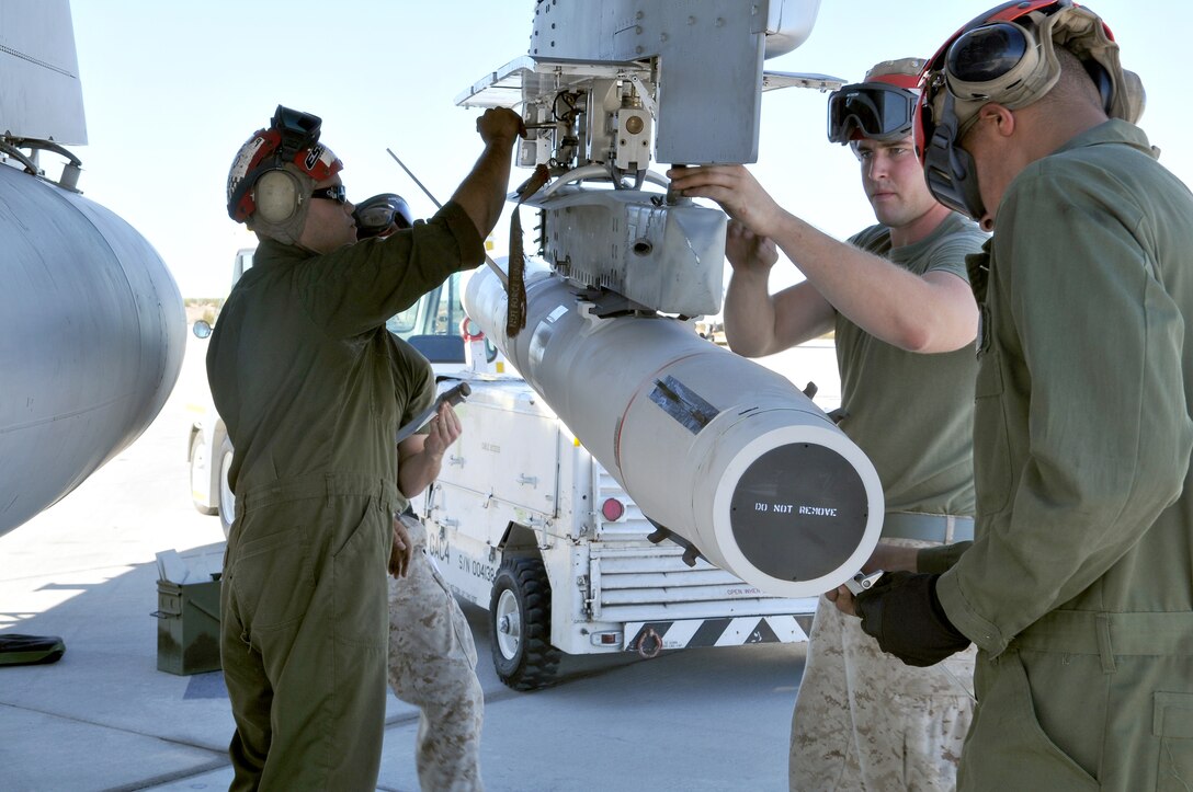 Marine Tactical Electronic Warfare Squadron 4 Marines prepare a high-speed, anti-radiation missile, after mounting it on an EA-6B Prowler jet at the Marine Corps Air Station in Yuma, Ariz., Oct. 8, 2010. The Prowler jets fired a total of 14 HARMs at targets in the Pacific Ocean as part of the Weapons and Tactics Instructor course, which gives the squadron the opportunity to train with live HARMs. “It was brand new for every one of the guys that was out there today,” said Staff Sgt. Robert Farmer, VMAQ-4 ordnance chief. “We’ve got one guy that’s been with us for three years and hadn’t touched a live HARM, and we’ve got another guy, who has only been with us for about a month and got lucky. So, the training was definitely important.” The squadron specializes in electronic warfare using the HARM, which detects electromagnetic radiation given off by enemy radars or anti-aircraft weapons, and is also the only missile Prowlers launch.