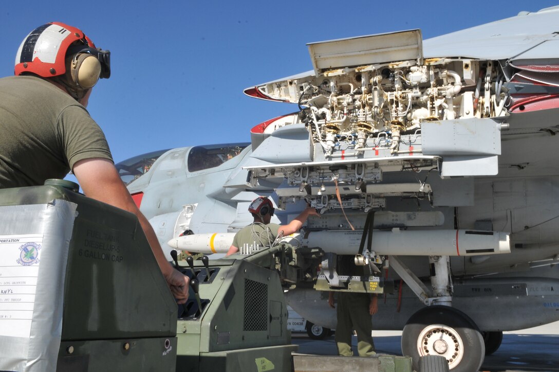 Lance Cpl. Adam Conley, Marine Tactical Electronic Warfare Squadron 4 ordnance technician, operates a short airfield tactical site loader to postition a high-speed, anti-radiation missile so the ordnance team can sercure it on an EA-6B Prowler jet at the Marine Corps Air Station in Yuma, Ariz., Oct. 8, 2010. The Cherry Point, N.C.,-based squadron fired a total of 14 HARMs at targets in the Pacific Ocean as part of the Weapons and Tactics Instructor course. The HARM finds its targets by detecting electromagnetic radiation and is also the only missile the Prowler jets fire.