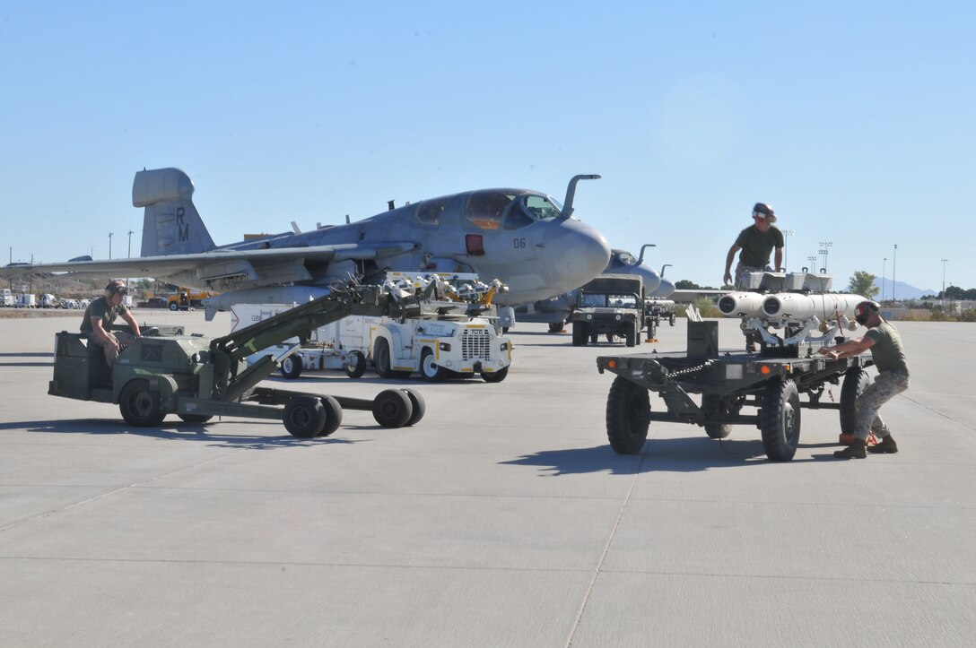 Lance Cpl. Adam Conley, Marine Tactical Electronic Warfare Squadron 4 ordnance technician, approaches Staff Sgt. Robert Farmer, VMAQ-4 ordnance chief, and Cpl. Jared Reader, VMAQ-4 ordnance technician, on a short airfield tactical site loader to reposition a high-speed, anti-radiation missile so they could secure it onto an EA-6B Prowler jet at the Marine Corps Air Station in Yuma, Ariz., Oct. 8, 2010. The Cherry Point, N.C.,-based squadron fired a total of 14 HARMs at targets in the Pacific Ocean as part of the Weapons and Tactics Instructor course in Yuma. The HARM finds its targets by detecting electromagnetic radiation and is also the only missile the Prowler jets fire.
