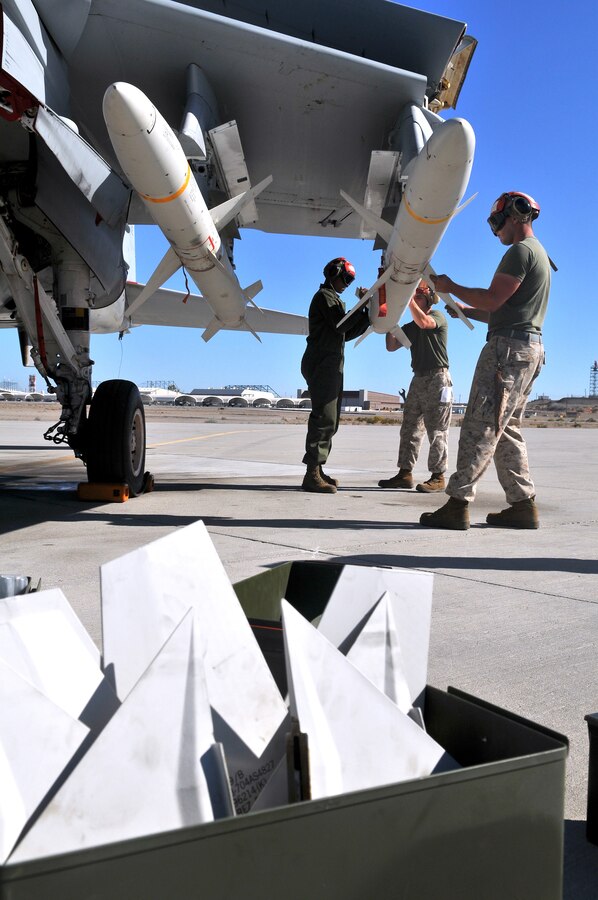 Marine Tactical Electronic Warfare Squadron 4 Marines based in Cherry Point, N.C., attach wings and fins to a high-speed, anti-radiation missile after they mounted it on an EA-6B Prowler jet at the Marine Corps Air Station in Yuma, Ariz., Oct. 8, 2010. The squadron fired 14 HARMs at targets in the Pacific Ocean as part of the Weapons and Tactics Instructor course in Yuma. The HARM finds its targets by detecting electromagnetic radiation and is the only weapon the Prowler jets launch.