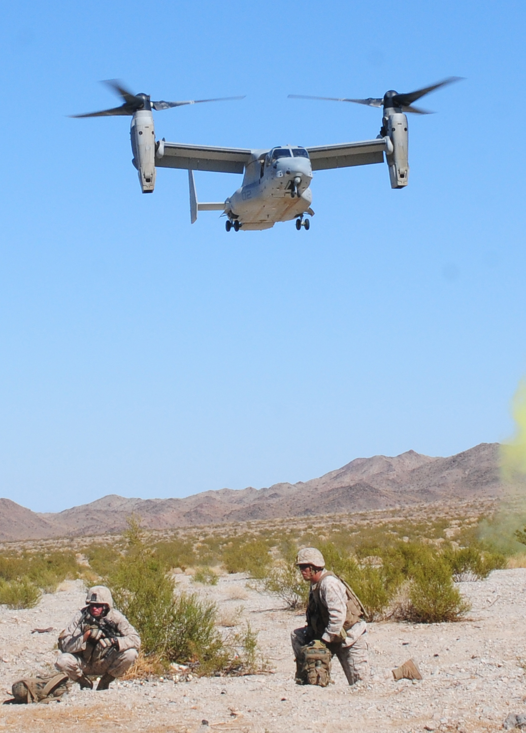 Marines from Company K, 3rd Battalion, 4th Marine Regiment, wait for an MV-22 Osprey to land and carry them back to the Marine Corps Air Station in Yuma, Ariz., after completing a raid at Marine Corps Air Ground Combat Center Twentynine Palms, Calif., Oct. 8, 2010. The training was in support of Yuma's semiannual Weapons and Tactics Instructor course, and is part of their monthlong predeployment course.
