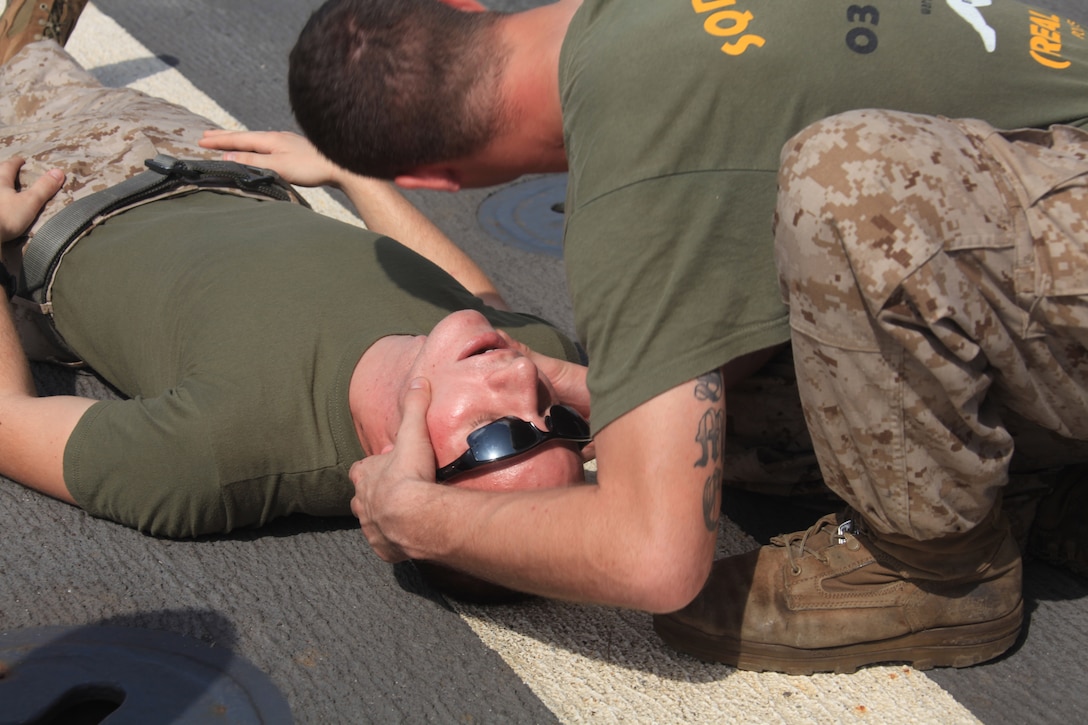 Cpl. Bryan Snow checks for breathing on Cpl. Sean Kinney, both infantrymen with 2nd Platoon, K Company, Battalion Landing Team 3/8, 26th Marine Expeditionary Unit, as they learn combat life saving skills on the flight deck of USS Ponce in the U.S. Navy Fifth Fleet Area of Responsibility, Oct. 9, 2009. 26th MEU continues to support relief operations in Pakistan and is also serving as the U.S. Central Command theater reserve force as elements of the MEU conduct training and planned exercises.