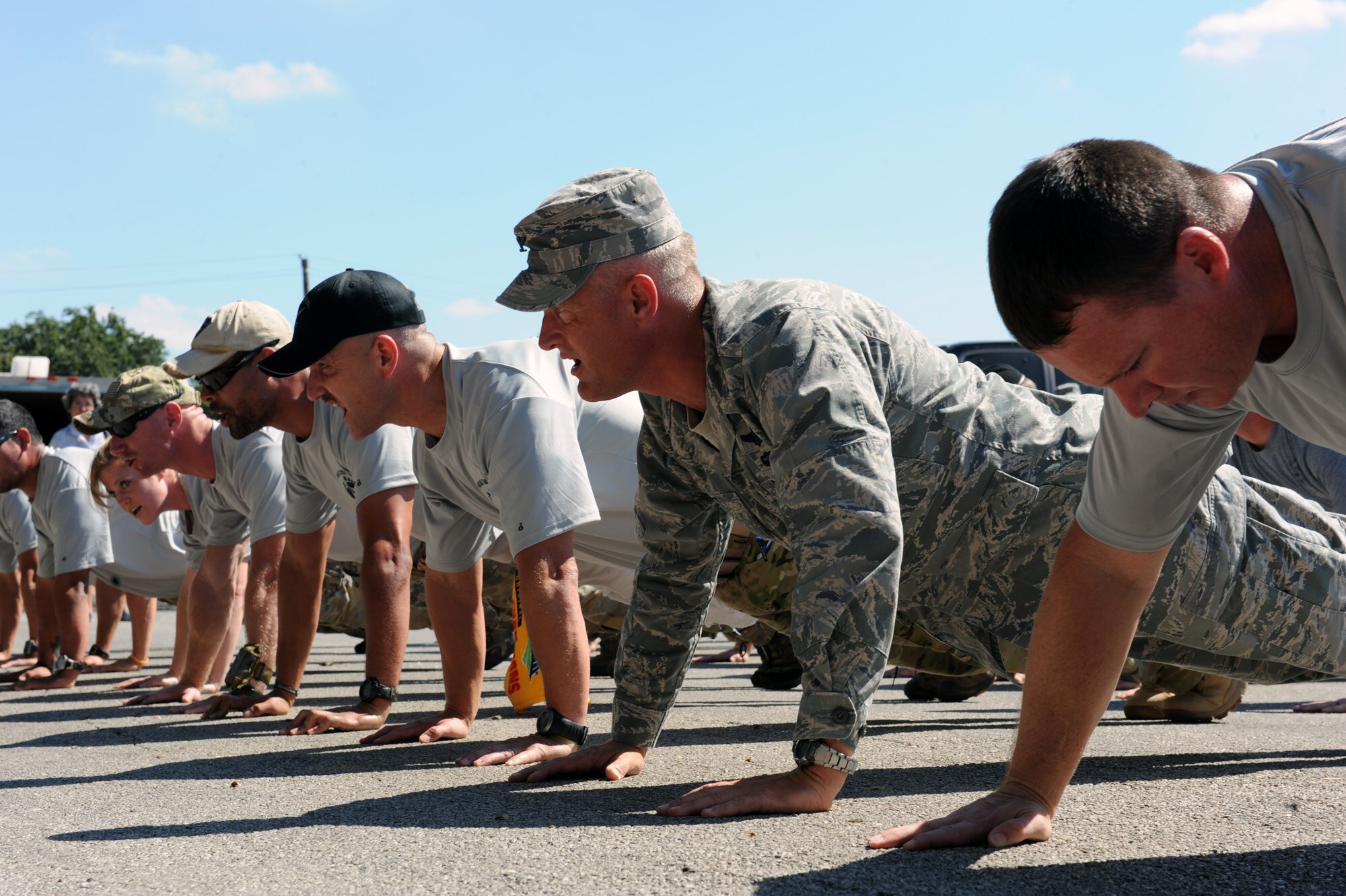 Col. William H. Mott V does push-ups to honor fallen special tactics Airmen during a ceremony Oct. 9, 2010, that marked the start of the Tim Davis Special Tactics Memorial March conducted by a 15-man team who will walk from Lackland Air Force Base, Texas, to Hurlburt Field, Fla.  Colonel Mott is the 37th Training Wing commander at Lackland AFB.  The journey will cover more than 800 miles and five states. (U.S. Air Force photo/Staff Sgt. Desiree N. Palacios)