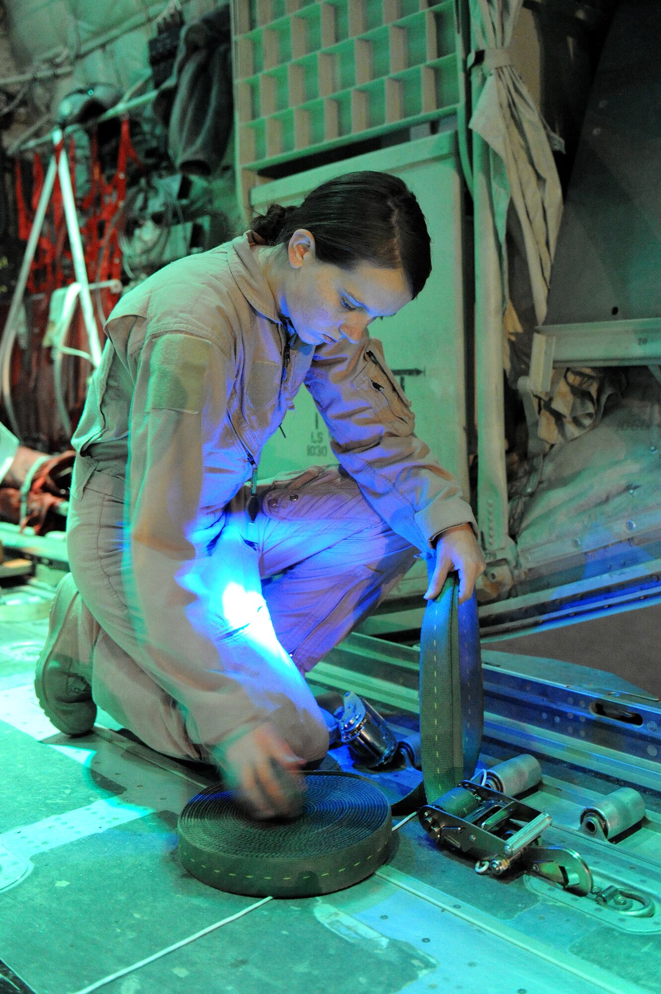 Airman 1st Class Rachael Orazine prepares to strap airdrop bundles in a C-130J Hercules Oct. 5, 2010, at Kandahar Airfield, Afghanistan.  Airman Orazine, a loadmaster assigned to the 772nd Expeditionary Airlift Squadron, hails from Gulfport, Miss. (U.S. Air Force photo by Tech. Sgt. Chad Chisholm/Released)