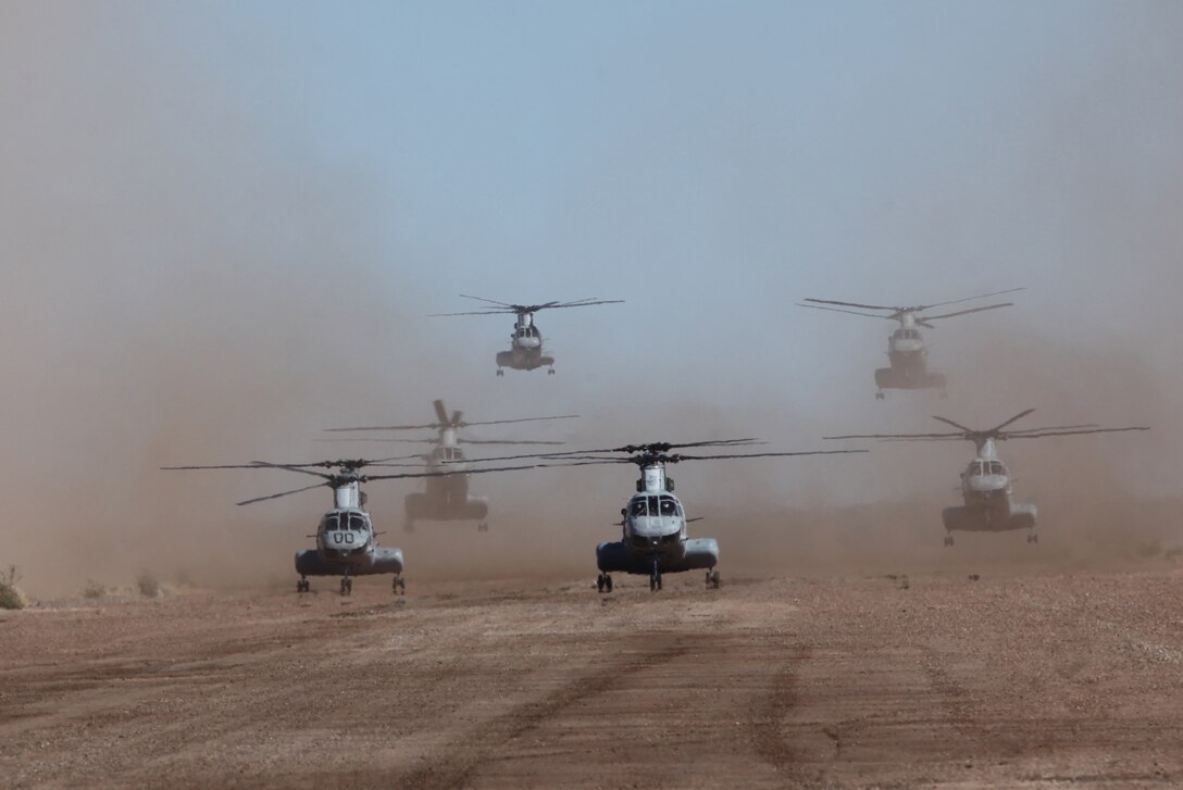 Six Marine Corps CH-46 helicopters land at Stoval Airfield, near Dateland, Ariz., Oct 9, 2010, to be refueled by the aircrew of a KC-130 Hercules aircraft during a training mission as part of Weapons and Tactics Instructor course. The course, hosted twice a year at the Marine Corps Air Station in Yuma, Ariz., by Marine Aviation and Weapons Tactics Squadron 1, trains Marine students from across the globe to return to their units as training officers versed in the latest aviation tactics and procedures. The Stoval Airfield is located within the Barry M. Goldwater Range in southwest Arizona. The versatile KC-130s are often used for aerial refueling of jets and helicopters, but can refuel from the ground as well.