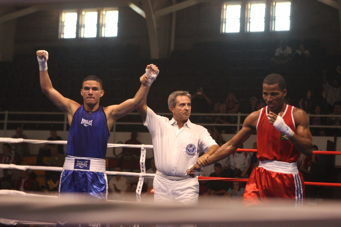 Lance Cpl. Tommy Roque (left), a boxer with the All-Marine Boxing Team, celebrates after his win against Brazilian boxer Sailor Robson Donato Conceicao after their lightweight bout at the 53rd World Military Boxing Championships, hosted by the Conseil International du Sport Militaire (International Military Sports Council) at the Goettge Memorial Field House aboard Marine Corps Base Camp Lejeune, Oct. 10. Military athletes from around the world compete in sports, such as boxing, with the CISM's motto at heart: "Friendship through Sport."