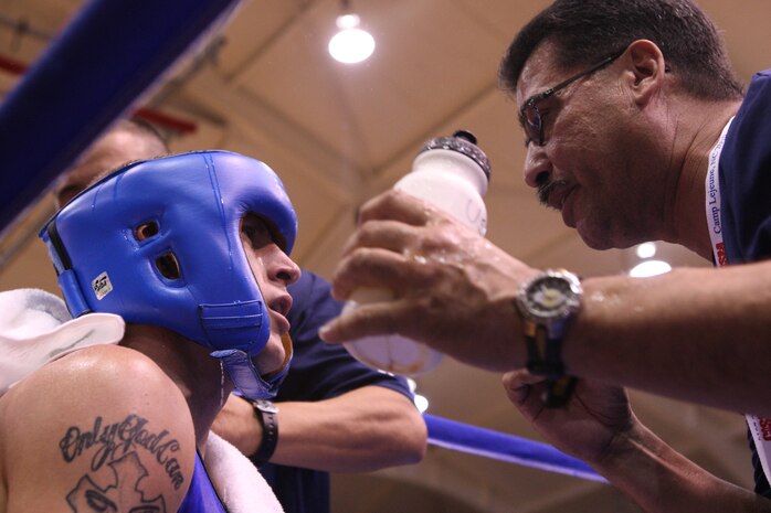 Spc. Samuel Vasquez Jr., a boxer with the Pennsylvania Army National Guard, receives a few pointers and medical aid from his corner during his bout with Sgt. Carsten Sorenson, a boxer representing Denmark, during the 53rd World Military Boxing Championships, hosted by the Conseil International du Sport Militaire (International Military Sports Council) at the Goettge Memorial Field House aboard Marine Corps Base Camp Lejeune, Oct. 10. Military athletes from around the world compete in sports, such as boxing, with the CISM's motto at heart: "Friendship through Sport."