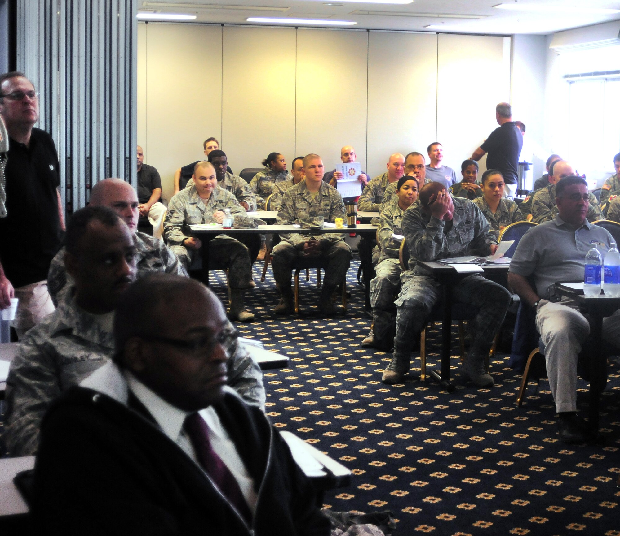 YOKOTA AIR BASE, Japan -- Attendees watch as a member from each mock exercise group presents their variations on base security protective measures and local terrorist treat levels, here Oct. 1. Both military and civilian personnel were in attendance during this five day Anti-Terrorism training seminar. (U.S. Air Force Photo/ Airman 1st Class Katrina R. Menchaca)