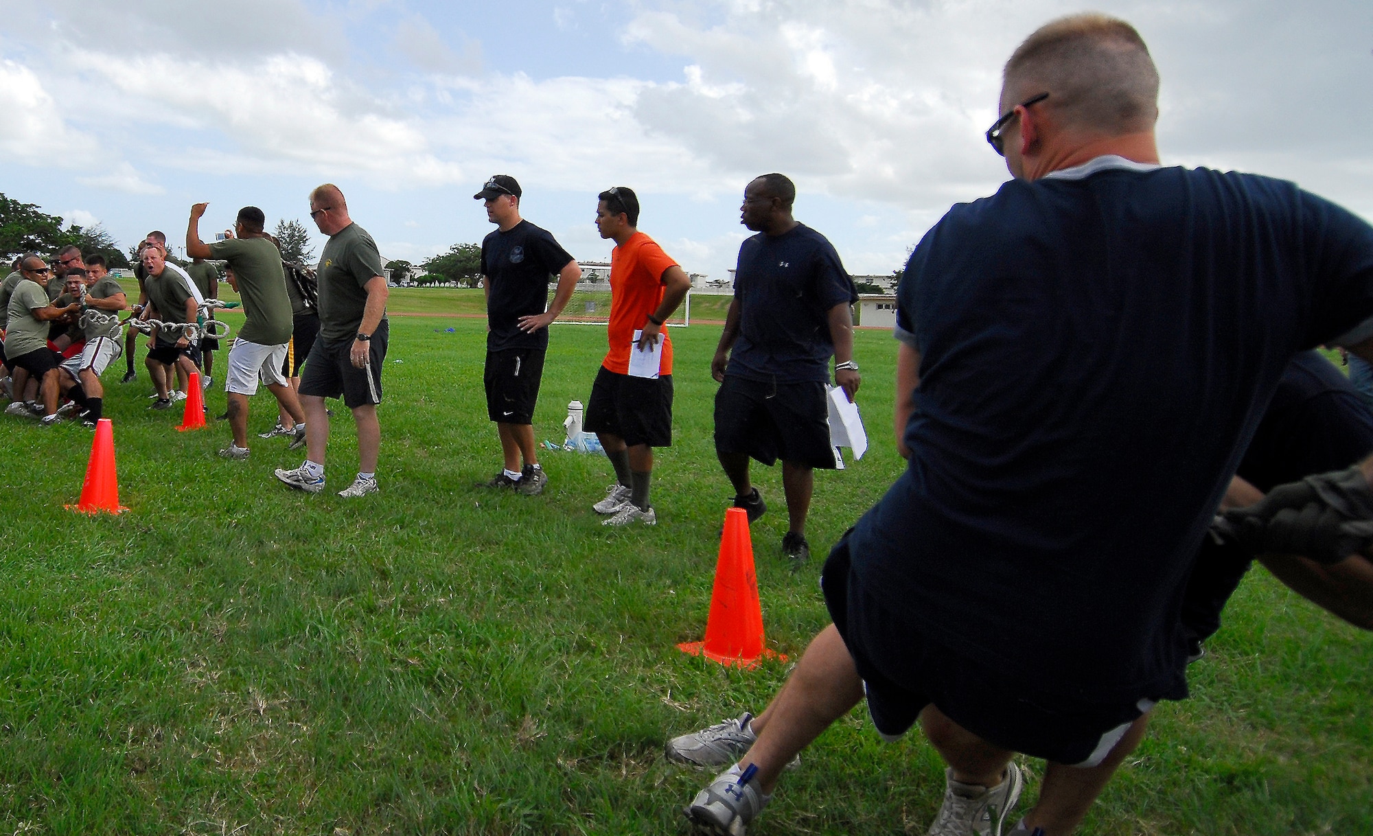 Members from the 18th Component Maintenance Squadron and Marines from Camp Hanson's 3rd Intelligence Battalion snap the tug-of-war rope in half during the DragonFest competition Sept. 24. After tying the rope back together, 18th CMS went on to win the tug-of-war competition, but 3rd IB became "Top Dragon" of the tournament. (U.S. Air Force photo/ Airman 1st Class Maeson L. Elleman)
