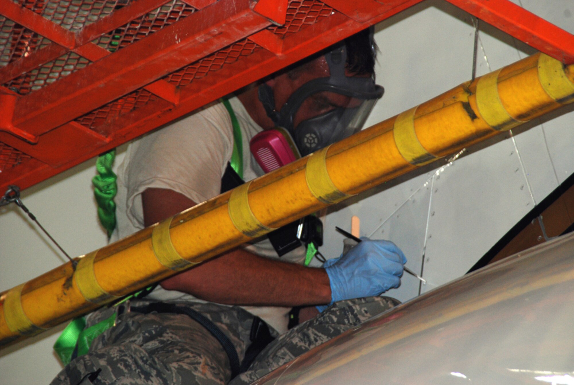 Staff Sgt. Joseph Steimann, 932nd Maintenance Squadron sheet metal shop, applies his "hands-on touch" with precision brush, adding white paint to the tail section of the C-40C owned by Air Force Reserve Command's 932nd Airlift Wing.  Small panels on the C-40 require periodic touch-up by a small brush to keep the aircraft looking crisp and uniform with the others in the fleet.  (U.S. Air Force photo/Tech. Sgt. Dan Oliver)
