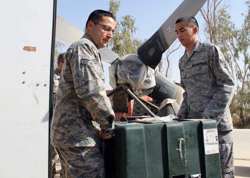 Senior Airman Noah Clifton and Airman 1st Class Jason Huynh, 332nd Expeditionary Logistics Readiness Squadron Material Management material management technicians, move a C-17 maintenance kit into an outside storage unit Oct. 1, 2010, Joint Base Balad, Iraq. As the 332 ELRS Material Management Airmen shrunk Balad’s supply footprint, they were able to consolidate operations from four buildings into two. Airman Clifton is a native of San Diego, Calif., deployed from Joint Base McGuire-Dix-Lakehurst, Md.; Airman Huynh is a native of San Jose, Calif., deployed from Barksdale Air Force Base, Calif. (U.S. Air Force photo/Tech. Sgt. Stacy Fowler)