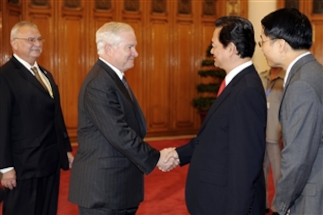 U.S. Defense Secretary Robert M. Gates, left, is greeted by Vietnamese Prime Minister Nguyen Tan Dung at the prime minister's office in Hanoi, Vietnam, Oct. 11, 2010.