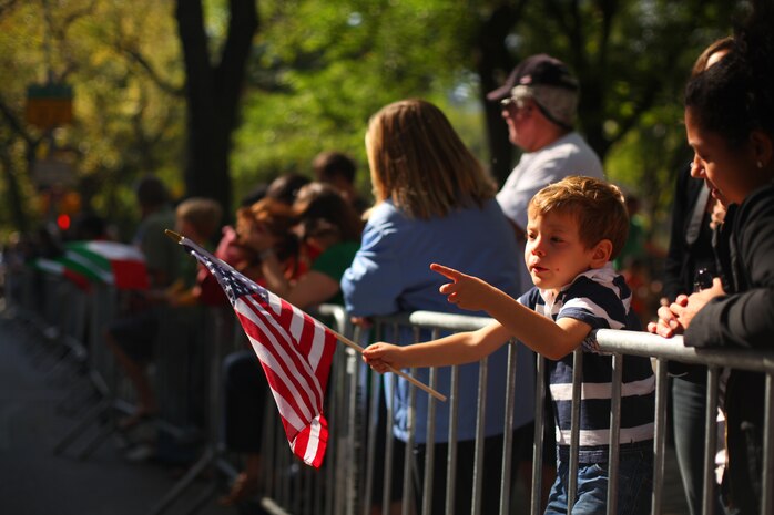 A child points to a passing marching unit during the annual Columbus Day Parade, here, Oct. 11. The parade organizers estimated more than 100 bands, floats and contingents marched in the annual parade and nearly one million spectators watched the procession.