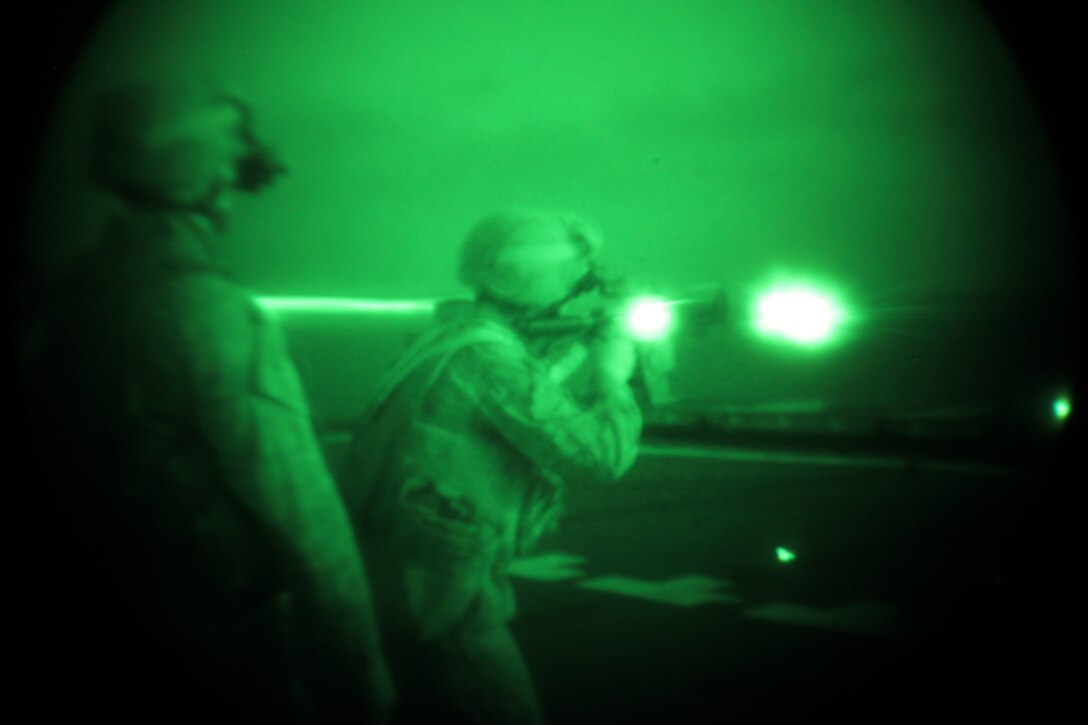 Sergeant Anthony Tripp, a military policeman with Military Police Detachment, Combat Logistics Battalion 26, 26th Marine Expeditionary Unit, fires an M4 service rifle during a night live-fire event aboard USS Ponce in the U.S. Navy Fifth Fleet Area of Responsibility, Oct. 12, 2010. 26th Marine Expeditionary Unit continues to support relief operations in Pakistan and is also serving as the U.S. Central Command theater reserve force as elements of the MEU conduct training and planned exercises.