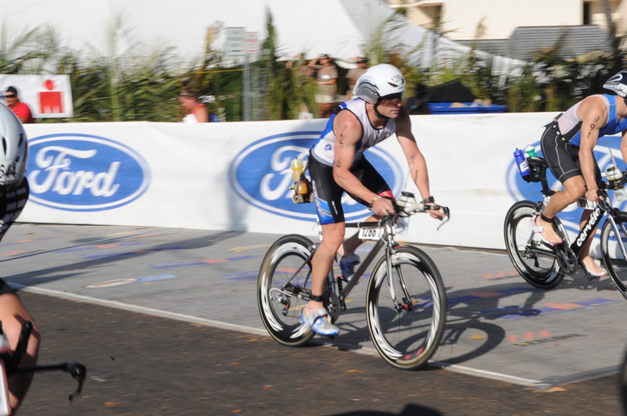 Maj. Scott Poteet speeds by the crowd after transitioning from the 2.4-mile swim to the 112-mile bike race while competing in the 2010 Ironman World Championship Oct. 9, 2010, at Kona, Hawaii.  Major Poteet is assigned to the U.S. Air Force Academy in Colorado Springs, Colo. He finished with an overall time of 9:39:05.  (U.S. Air Force photo/Tech Sgt. Cohen A. Young)