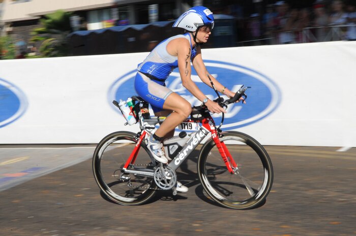 Capt. Jamie Turner speeds by the crowd after transitioning from the 2.4-mile swim to the 112-mile bike race while competing in the 2010 Ironman World Championship Oct. 9, 2010, at Kona, Hawaii.  Captain Turner is a C-17 Globemaster III pilot at Joint Base Charleston, S.C. She finished with an overall time of 10:48:31.  (U.S. Air Force photo/Tech Sgt. Cohen A. Young)