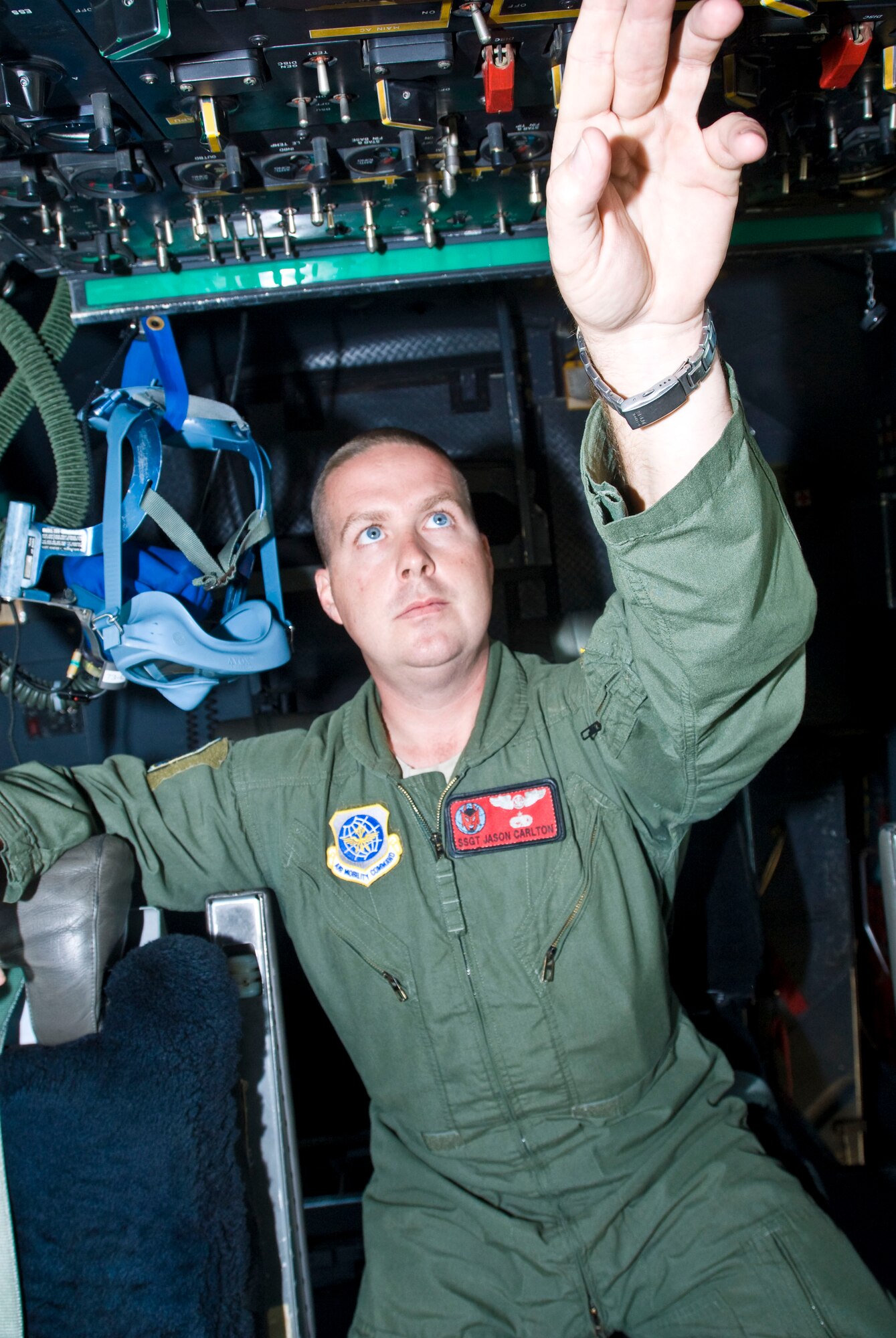 Staff Sgt. Jason Carlton, a 50th Airlift Squadron C-130 flight engineer, demonstrates which knobs are turned for a preflight checklist Tuesday inside a C-130H aircraft. The Moultrie, Ga., native has flown 60 combat missions and 242 sorties during a recent deployment, delivering almost 4,000 passengers and 300 tons of cargo. (U.S. Air Force photo by Staff Sgt. Nestor Cruz)
