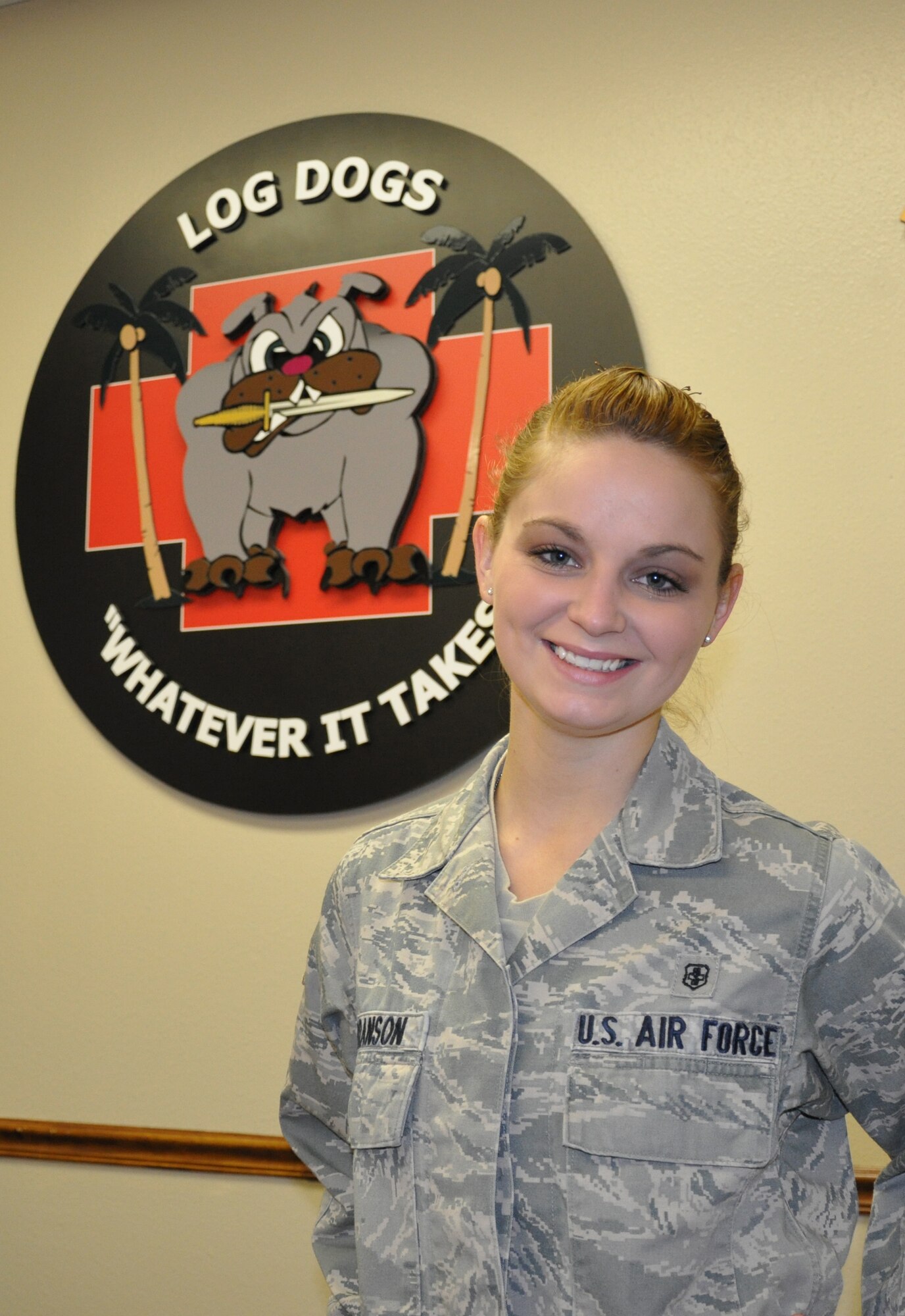 Airman 1st Class Veronica Branson, 1st Special Operations Medical Support Squadron medical logistics journeyman, poses next to her squadron's logo at her squadron at Hurlburt Field, Fla., Oct. 12, 2010. Airman Branson was selected for this week's Tip of the Spear spotlight. (DoD photo by U.S. Air Force Airman 1st Class Joe McFadden) (RELEASED)
